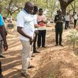 Mourners stand beside the grave of slain Ghanaian investigative journalist Ahmed Husein Suale who was gunned down in January as he returned to his home in Accra
