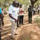 Mourners stand beside the grave of slain Ghanaian investigative journalist Ahmed Husein Suale who was gunned down in January as he returned to his home in Accra