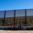 A family from El Salvador is pictured walking to turn themselves into Border Patrol agents after crossing the Rio Grande to claim asylum in El Paso, Texas
