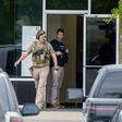 U.S. Immigration and Customs Enforcement officials stand outside CVE Technology Group in Allen, Texas. [Smiley N. Pool/The Dallas Morning News]