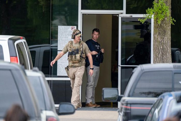 U.S. Immigration and Customs Enforcement officials stand outside CVE Technology Group in Allen, Texas. [Smiley N. Pool/The Dallas Morning News]