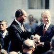 US President Jimmy Carter is between Egypt's President Anwar Sadat (L) and Israeli Prime Minister Menachem Begin (R) at the signature of the Egypt-Israel Peace Treaty on March 26, 1979