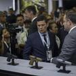 Brazilian Justice Minister Sergio Moro (C) looks at guns during the Latin American Defense and Security exhibition (LAAD 2019) in Rio de Janeiro, Brazil, on April 2, 2019