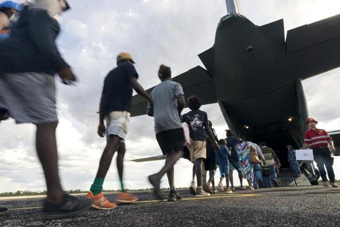 Residents of McArthur River, a remote town in the Northern Territory, boarding an Australian military plane as authorities evacuate communities in the path of a powerful cyclone