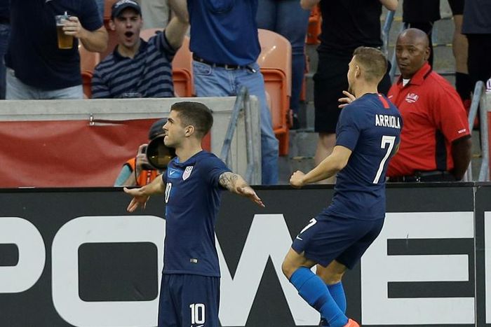 Christian Pulisic #10 of the USA celebrates with teammate Paul Arriola after scoring in the first half of a 1-1 friendly draw with Chile in Houston