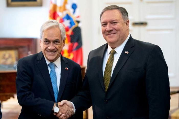 Chilean President Sebastian Pinera shakes hands with US Secretary of State Mike Pompeo (R) at La Moneda Presidential palace in Santiago, April 12, 2019