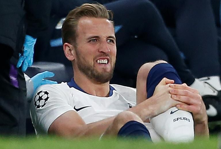 Tottenham striker Harry Kane receives medical treatment after hurting his ankle during the Champions League quarter-final against Manchester City