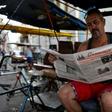 A man reads a slimmed-down edition of Cuban daily Granma in Havana, part of the country's first newspaper cut since 1990