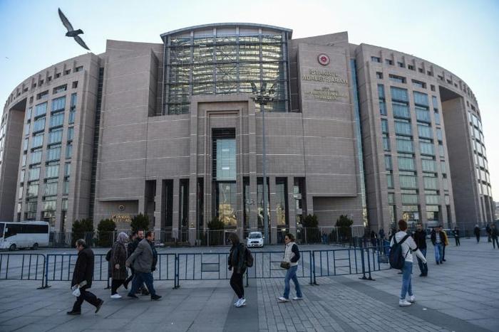Turkish police escorted Topuz into the Caglayan courthouse in Istanbul, where he faces life in jail if found guilty