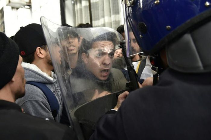 Algerian students scuffle with security forces during a protest in the capital Algiers against ailing President Abdelaziz Bouteflika's bid for a fifth term, on February 26, 2019
