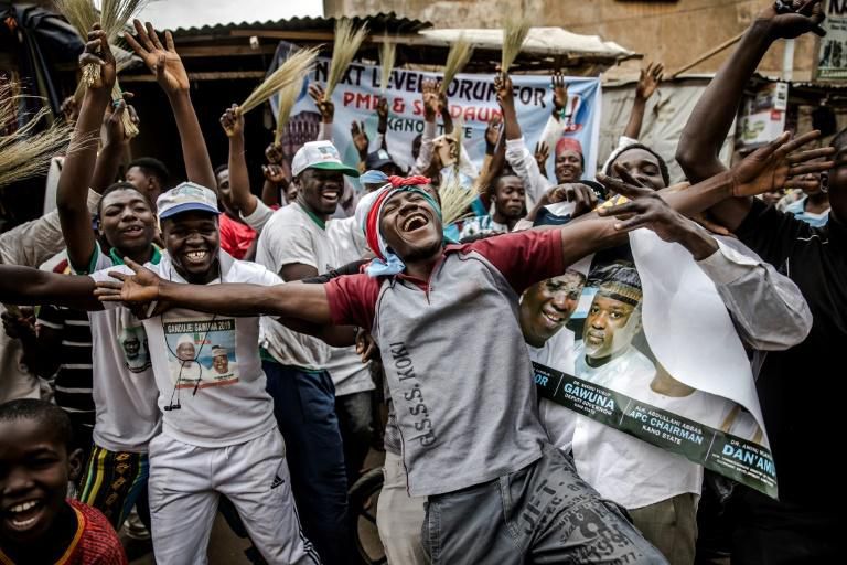 Supporters of President Buhari celebrate his re-election although the reaction was generally more muted than last time