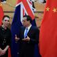 New Zealand Prime Minister Jacinda Ardern listens to Chinese Premier Li Keqiang during a signing ceremony after their meeting at the Great Hall of the People in Beijing on Monday