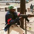 A fighter with Charles Taylor's NPFL fires at rivals from the United Liberation Movement of Liberia for Democracy (ULIMO) during Liberia's civil war in May 1996