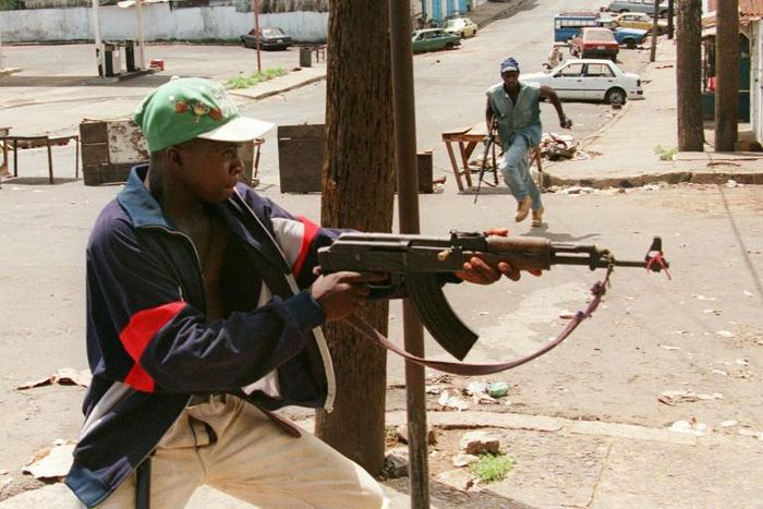 A fighter with Charles Taylor's NPFL fires at rivals from the United Liberation Movement of Liberia for Democracy (ULIMO) during Liberia's civil war in May 1996