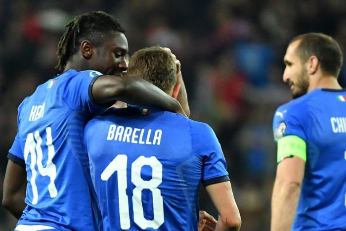 Italy's midfielder Nicolo Barella (C) and Moise Kean (L) scored in either half against Finland