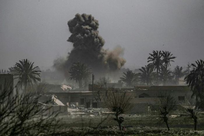 Smoke plumes billows after shelling of the Islamic State (IS) group's last holdout of Baghouz in eastern Syria near the border with Iraq