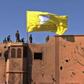 US-backed fighters of the Syrian Democratic Forces raise their flag in the Islamic State group's last redoubt of Baghouz as their commanders proclaim the total elimination of its "caliphate"