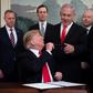 US President Donald Trump hands his pen to Israeli Prime Minister Benjamin Netanyahu after signing a proclamation recognizing the Golan as Israeli territory despite UN resolutions that state the strategic plateau is Syrian