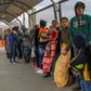 In this file photo taken on January 9, 2019 migrants from Cuba, Venezuela and Central America queue at the Paso del Norte International Bridge in Ciudad Juarez, Mexico, to cross the border and request political asylum in the United States
