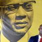 The founder of Guinea-Bissau's PAIGC party, Amilcar Cabral, looks down as spokesman Joao Bernardo Vieira speaks to the press
