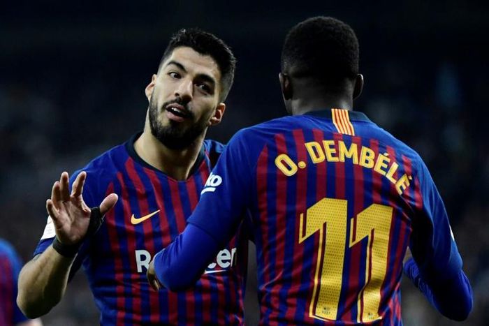 Man of the moment: Barcelona forward Luis Suarez celebrates with Ousmane Dembele