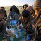 Yezidi boys share a meal in Syrian Democratic Forces-held territory after escaping the last scrap of the Islamic State group's collapsed "caliphate"