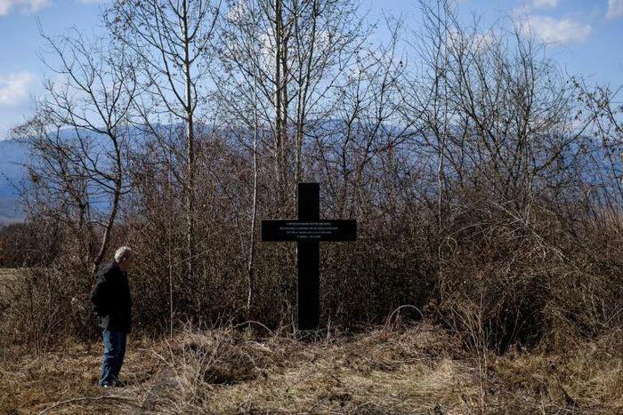 Retired doctor Miroslav Stosic, 71, by the memorial to the civilians killed 20 years ago by NATO bombs in southern Surdulica