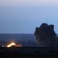 A military plane with the US-backed coalition against IS releases a bomb over the embattled village of Baghouz
