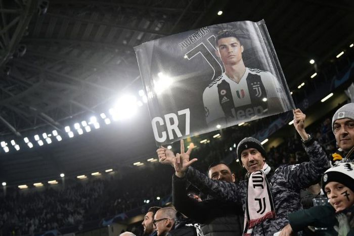 A fan displays a poster of Juventus' Portuguese forward Cristiano Ronaldo prior to the UEFA Champions League round of 16 second-leg football match in Turin.