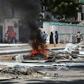 Fires are seen on a street following protest against the shooting by security forces of a rickshaw driver and his passenger, on April 13, 2019 in Mogadishu. Somali security forces shot dead a rickshaw driver and his passenger in the capital on Saturday...