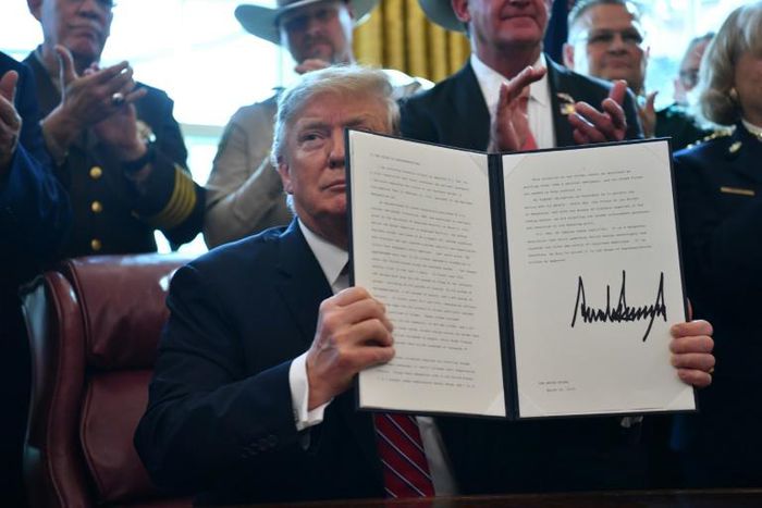 US President Donald Trump displays his veto, which overrides congressional opposition to his declaration of a national emergency at the Mexican border
