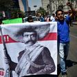 Teachers shout slogans carrying a banner depicting Mexican revolutionary leader Emiliano Zapata during a protest in Mexico City