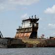 Graveyard: Dozens of shipwrecks and abandoned barges litter the Lagos waterways