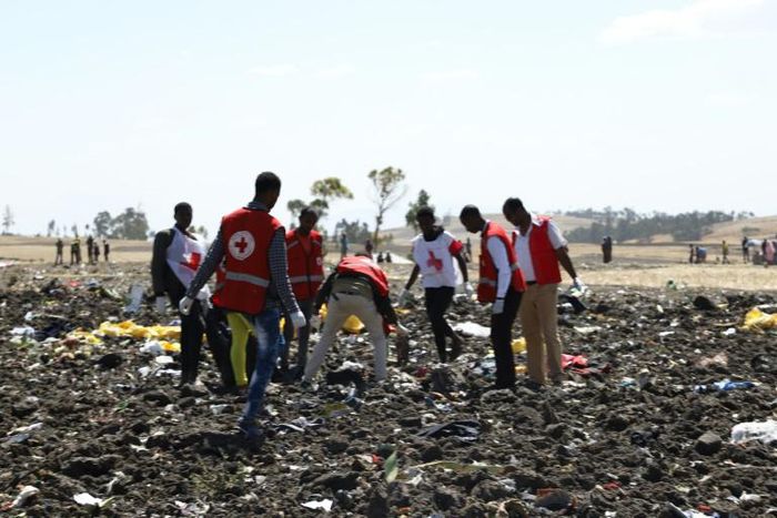 Red cross teams work through the debris after an Ethiopia Airlines flight to Nairobi crashed shortly after take-off from Addis Ababa, killing all 157 on board