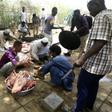 Sudanese protesters cut the meet of sheep and cows that they slaughtered as they celebrate the ousting of longtime leader Omar al-Bashir outside the army complex in the capital Khartoum