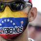 "We'll be back" reads the mask on this demonstrator at the Tienditas International Bridge in Cucuta, Colombia ahead of trying to cross humanitarian aid over the border into Venezuela