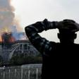Anxious passersby watched the landmark cathedral burn
