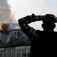 Anxious passersby watched the landmark cathedral burn