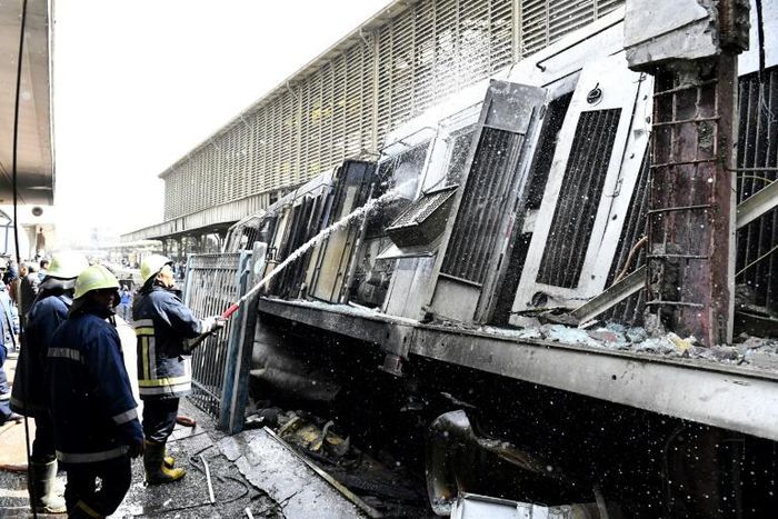 Fire fighters at the scene of a train crash in the Egyptian capital on February 27, 2019