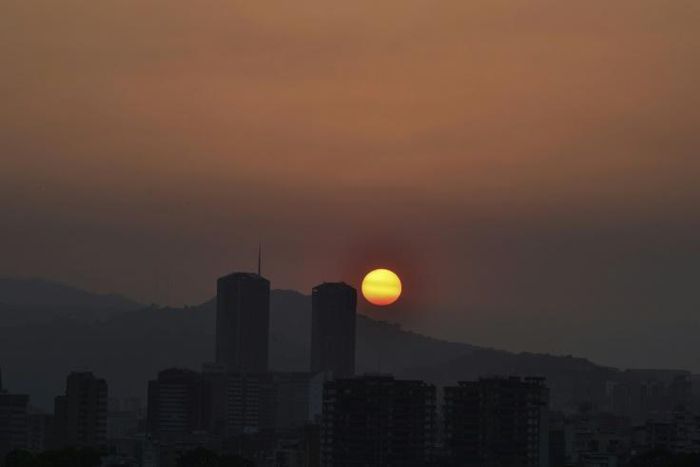 The sun sets in Caracas during a partial power cut on March 25, 2019