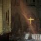 Smoke rises around the alter in front of the cross inside the Notre-Dame Cathedral in Paris as firefighters continued to extinguish the blaze on Tuesday