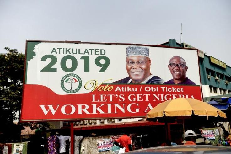 A campaign billboard bearing images of Peoples Democratic Party candidate Atiku Abubakar and his running mate Peter Obi stands on a road in Abuja on February 19, 2019, ahead of the rescheduled elections whose result Abubakar disputes