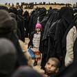 Women and children queue at a screening point after fleeing the Islamic State group's last redoubt in Syria