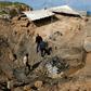 Palestinians check the site of an Israeli air strike in the southern Gaza Strip March 7, 2019