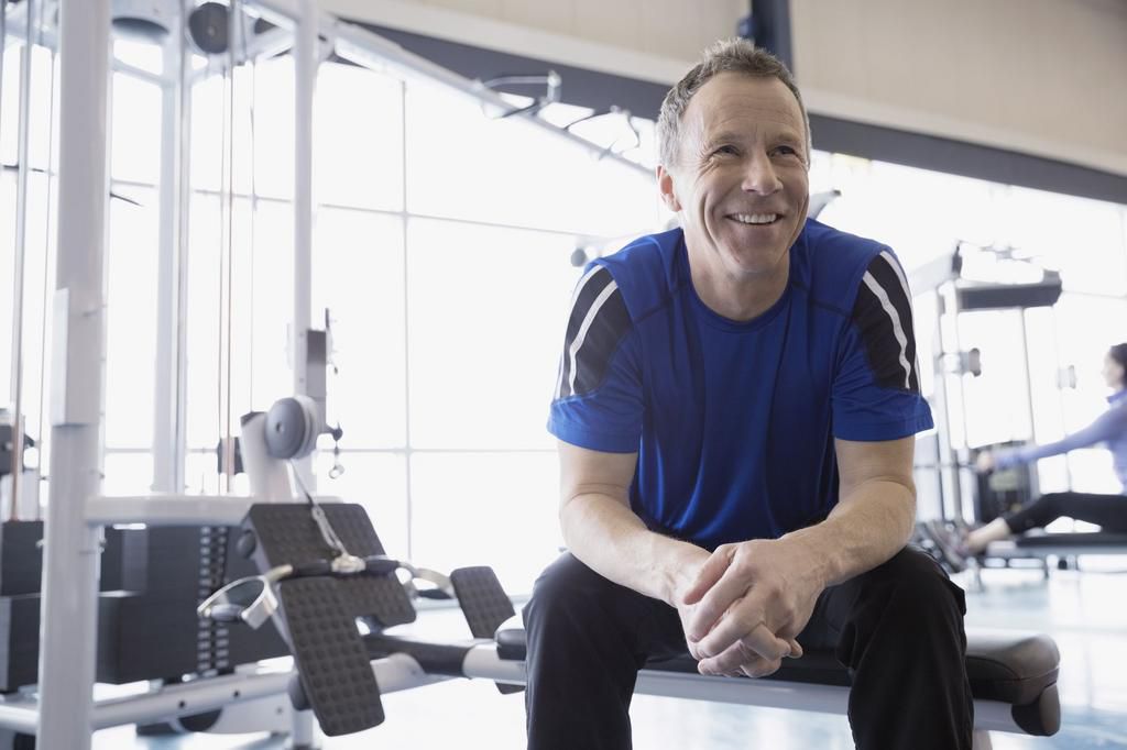 Smiling man resting at gym