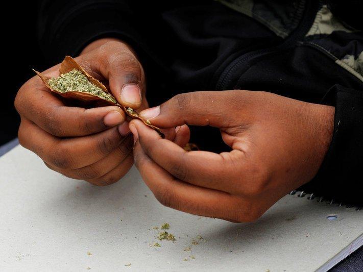 FILE PHOTO --  People roll a marijuana joint on the informal cannabis holiday, 4/20, corresponding to the numerical figure widely recognized within the cannabis subculture as a symbol for all things marijuana, on the Common in Boston, Massachusetts, U....