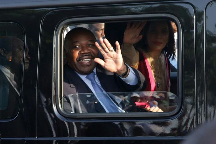 Gabonese President Ali Bongo Ondimba waves from his car upon returning to Libreville on Saturday after suffering a stroke and being treated in Morocco