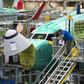 Boeing employees work on a 737 MAX jet at the company's factory in Renton, Washington -- the aviation giant has unveiled a fix to the software system of the jet, which has suffered two deadly crashes in recent months
