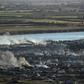 Smoke rises above the remains of the makeshift encampment on the north bank of the Euphrates River that had been the centre of the Islamic State group's last stand before it was overrun by the US-backed Syrian Democratic Forces earlier this week