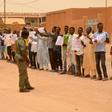 Migrants hold up banners to protest violence against refugees as UN refugee chief Filippo Grandi visits Agadez last June